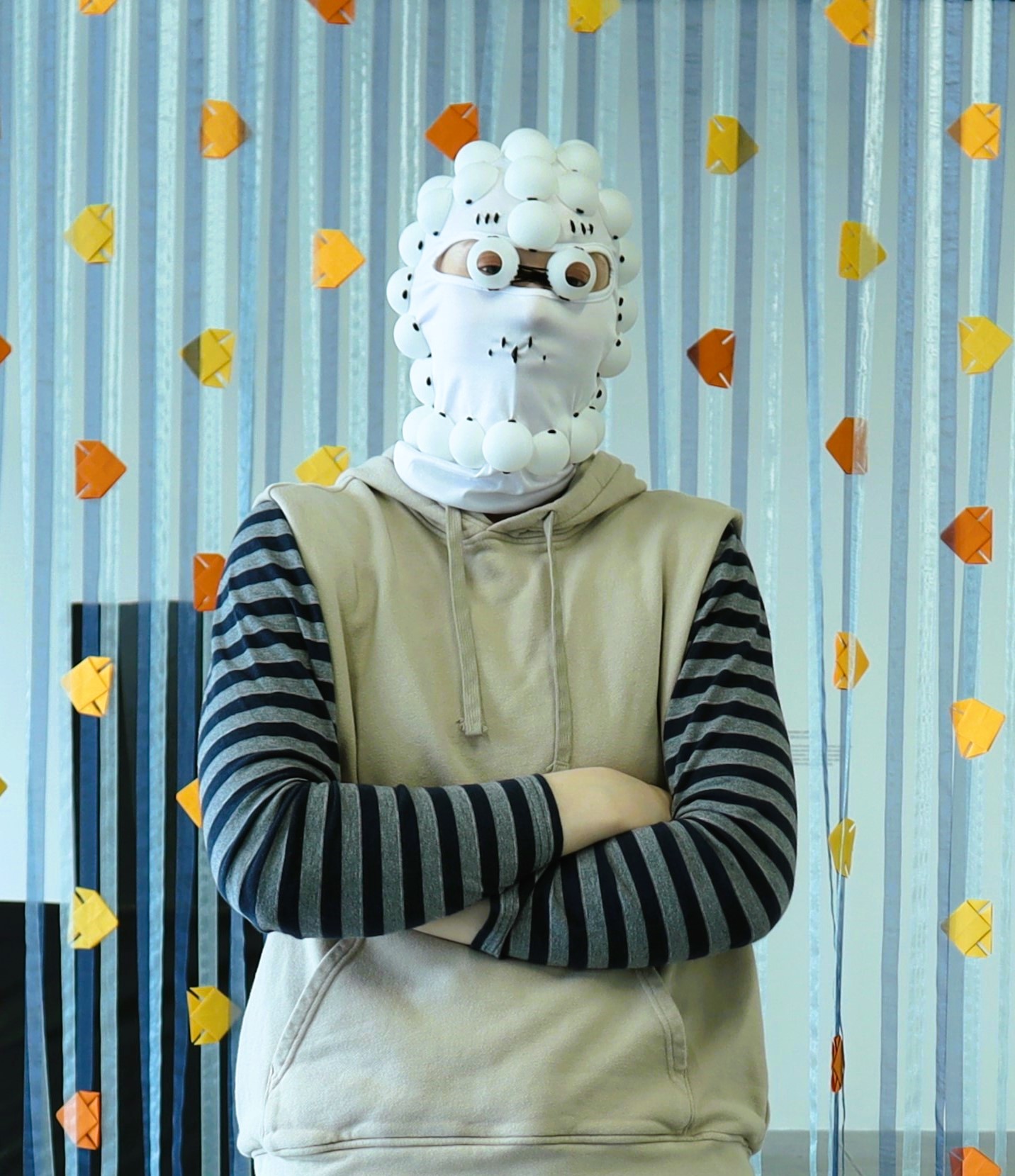 Photo of Anya wearing her ping pong mask from her Selves piece.
